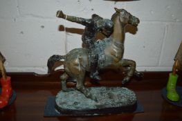A bronze model of a polo player on horseback.