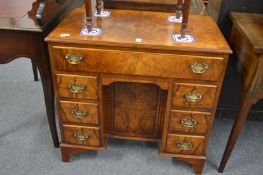 A Georgian style walnut kneehole pedestal desk.