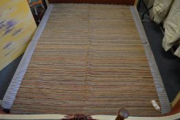 A Paul Smith inspired Kilim rug of multi-coloured striped design.