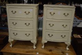 A pair of cream painted bedside chests.