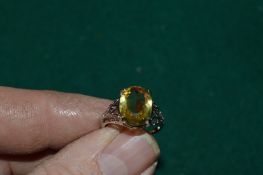 A silver filigree ring set with a 4.9ct oval cut citrine with certificate.