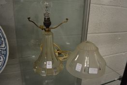 An Art Deco design cut and etched glass table lamp with shade.