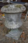 A classical urn style reconstituted stone garden planter.