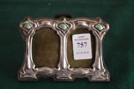 An Art Nouveau style miniature double photograph frame.