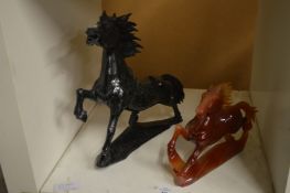 Two carved hard stone models of prancing horses.