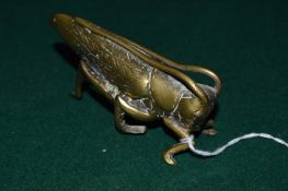 Cast brass model of a cicadas.