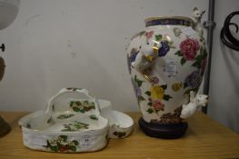 A strawberry dish and a decorative porcelain vase.