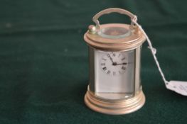 A small silver plated carriage clock.