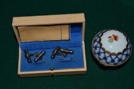 A pair of cufflinks and porcelain box.