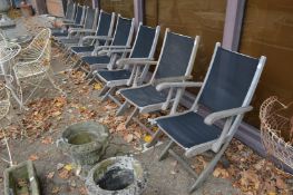 A set of eight hardwood framed folding garden chairs.