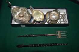 A small group of silverware to include sauce boat, toasting fork and other items.