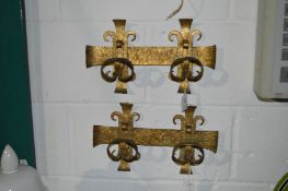 A pair of gilded wrought iron wall hooks.