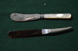 Silver handled letter opener and a silver bladed butter knife.