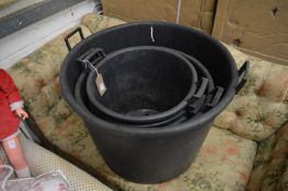 Five large plastic twin handled storage buckets.