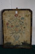 A 17/18th century silk work picture depicting a vase of flowers with animals, birds and insects in a