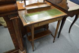 An Edwardian rosewood writing table with fitted upper section and green leather inset writing
