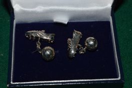 A pair of football and football boot cufflinks.