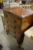A 1940's walnut chest of drawers on cabriole legs.