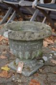 A classical urn style reconstituted stone garden planter.