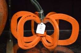 A wrought iron pumpkin shaped T light holder.
