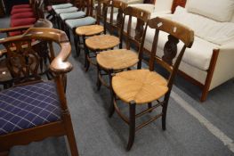 A set of four rush seated elm dining chairs.