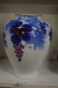 A Japanese Fukagawa porcelain vase decorated with fruiting vine.