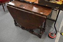 An 18th century oak drop-leaf gateleg dining table.