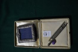 A small silver photograph frame and other items.