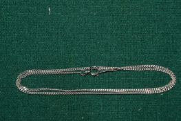 A white metal fine link chain stamped 18k.