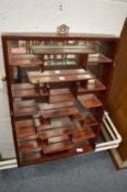 A Chinese hardwood mirror back display shelf.