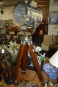 A large spotlight style floor standing lamp with tripod base.