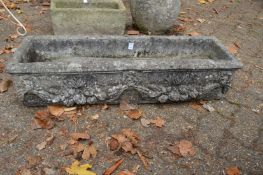 A reconstituted stone rectangular plant trough.