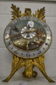 A decorative cast metal strut clock with painted dial.
