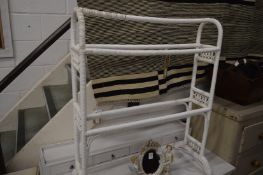 A wicker work towel rail and a bamboo dressing table seat.