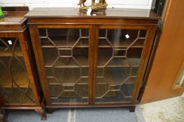 A mahogany display cabinet with pair of astragal glazed doors.