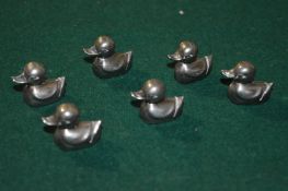 A set of six duck shaped menu or place name holders.