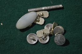 Silver cufflinks, buttons and propelling pencil.
