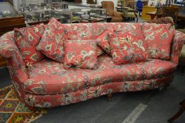 Wesley-Barrell, a large settee with curving back and arms, upholstered in a pink ground paisley