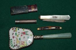 A small Chinese hand mirror and other items.