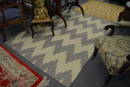 A Madeline Weinrib Kilim rug of grey and cream zig-zag design, 227cm x 175cm.