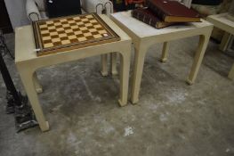 A pair of cream painted occasional tables.
