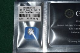 A 2.5ct Moissanite stone, 8.5mm diameter, with certificate.