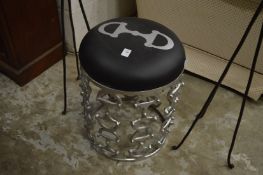 A decorative metal framed stool.