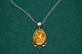 A silver pendant and chain.