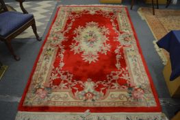 A Chinese rug, red ground with floral decoration, 250cm x 150cm.