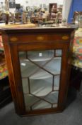 A 19th century inlaid mahogany hanging corner cabinet with astragal glazed door.