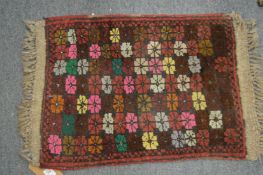 A small Persian style mat, 65cm x 44cm.
