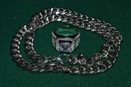 A heavy stainless steel necklace and decorative ring.