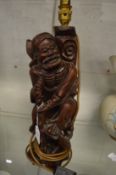 A Japanese carved root wood figural table lamp.