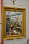 A small gilt framed mirror.